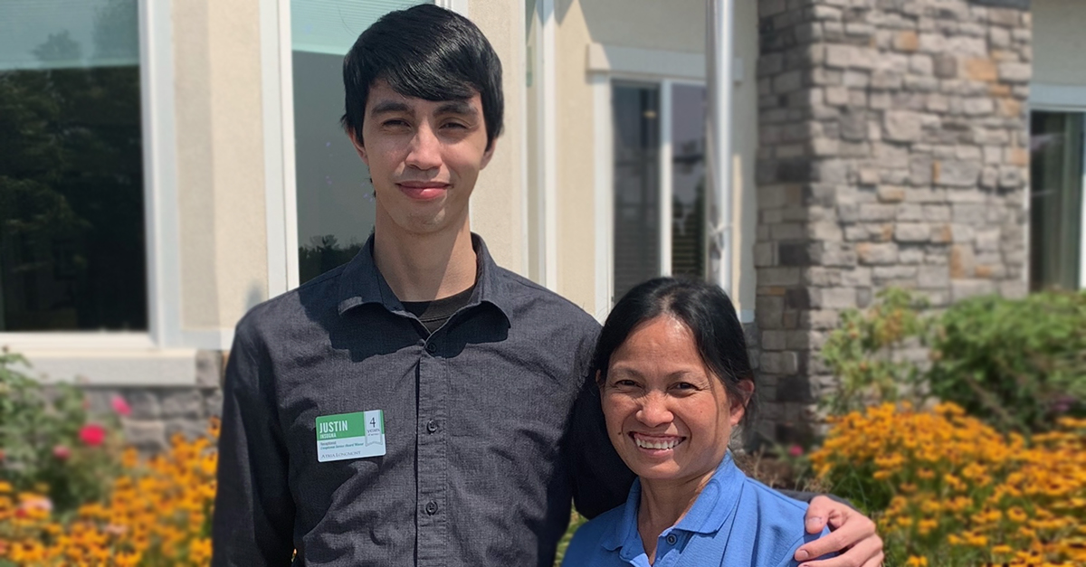 Atria Senior Living mother and son coworkers smiling together.